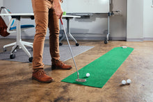 Load image into Gallery viewer, Close up view of man practicing golf putts on PUTT-A-BOUT Par 1 "360" Putting Mat in office