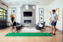 Load image into Gallery viewer, Man and woman couple competing on PUTT-A-BOUT XL312 3x12 Putting Mat in home setting