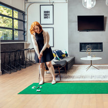 Load image into Gallery viewer, Woman practicing putts on PUTT-A-BOUT XL215 Putting Mat in residential setting
